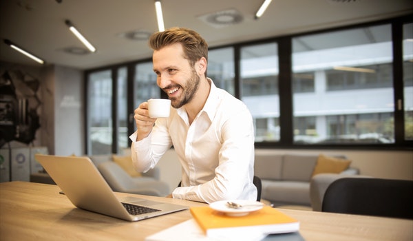 depth-of-field-photo-of-man-sitting-on-chair-while-holding-927451.jpg